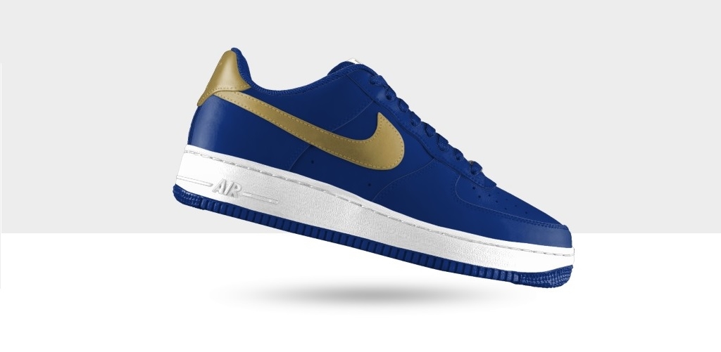 royal blue nike casual shoes with white soles and a gold swoosh