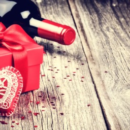 bottle of wine, red gift box and a plush heart