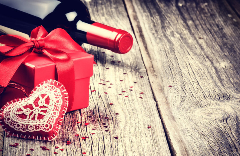 bottle of wine, red gift box and a plush heart