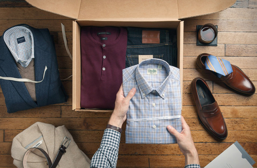 man putting neatly folded dress shirt into drawer