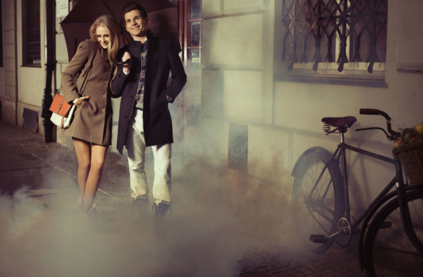 woman and man walking down urban street wearing spring clothes