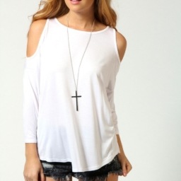 Woman in cut out shoulder top shirt wearing crucifix necklace