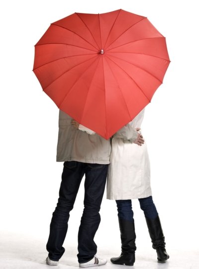 Couple under heart-shaped umbrella