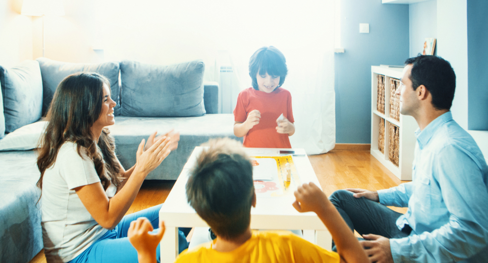 Family playing board game at home.